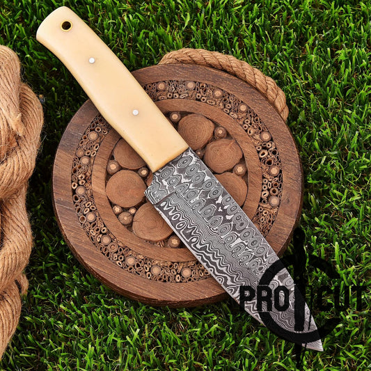 Decorative knife with a wooden handle on a wooden cutting board with a grass background