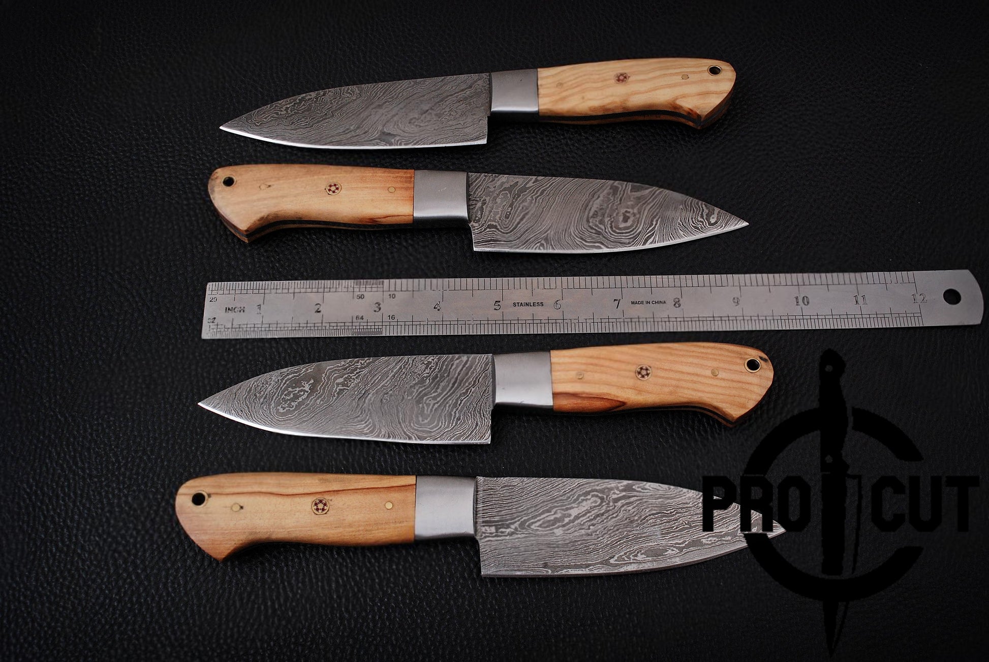 Four knives with wooden handles and metal blades on a black background, accompanied by a ruler.