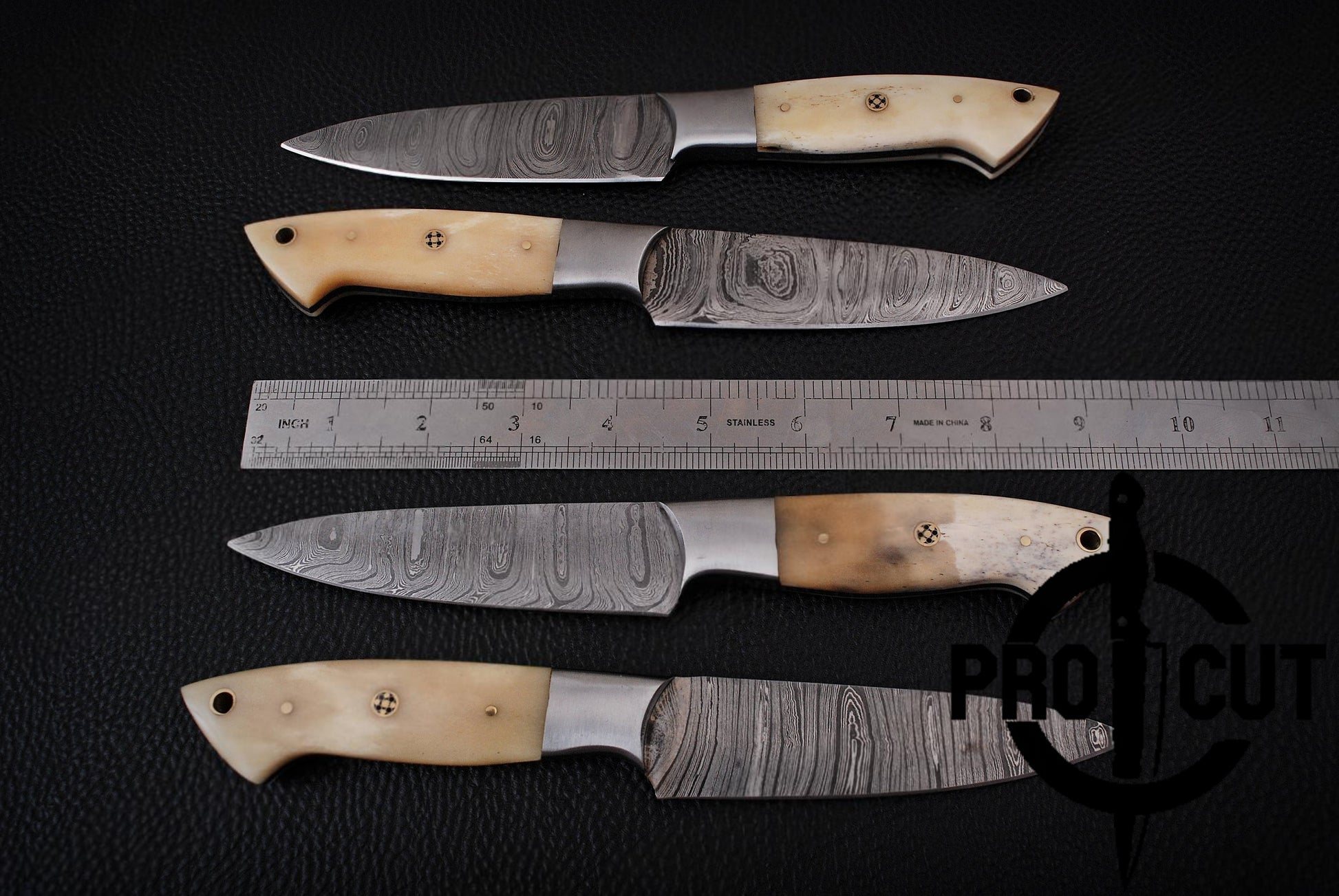 Four knives with wooden handles and metal blades on a dark surface, with a ruler for scale. 'Pro Cut' branding visible.
