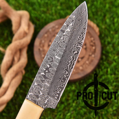 Decorative knife with wavy pattern on a wooden block against a green grass background, featuring the Pro Cut logo.