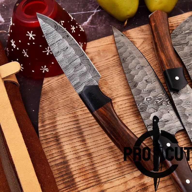 Two Damascus steel knives on a wooden cutting board with a ProTcut logo.