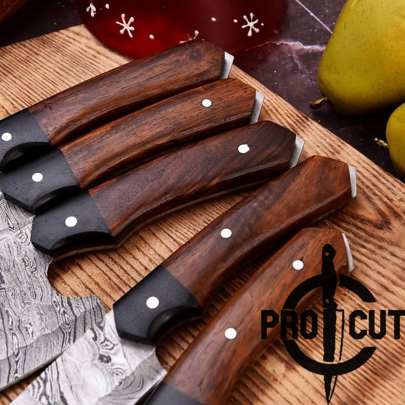 Set of knives with wooden handles on a wooden surface, featuring the Pro Cut logo.