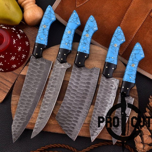 Set of knives with blue handles on a wooden surface, featuring the brand 'Pro Cut'.